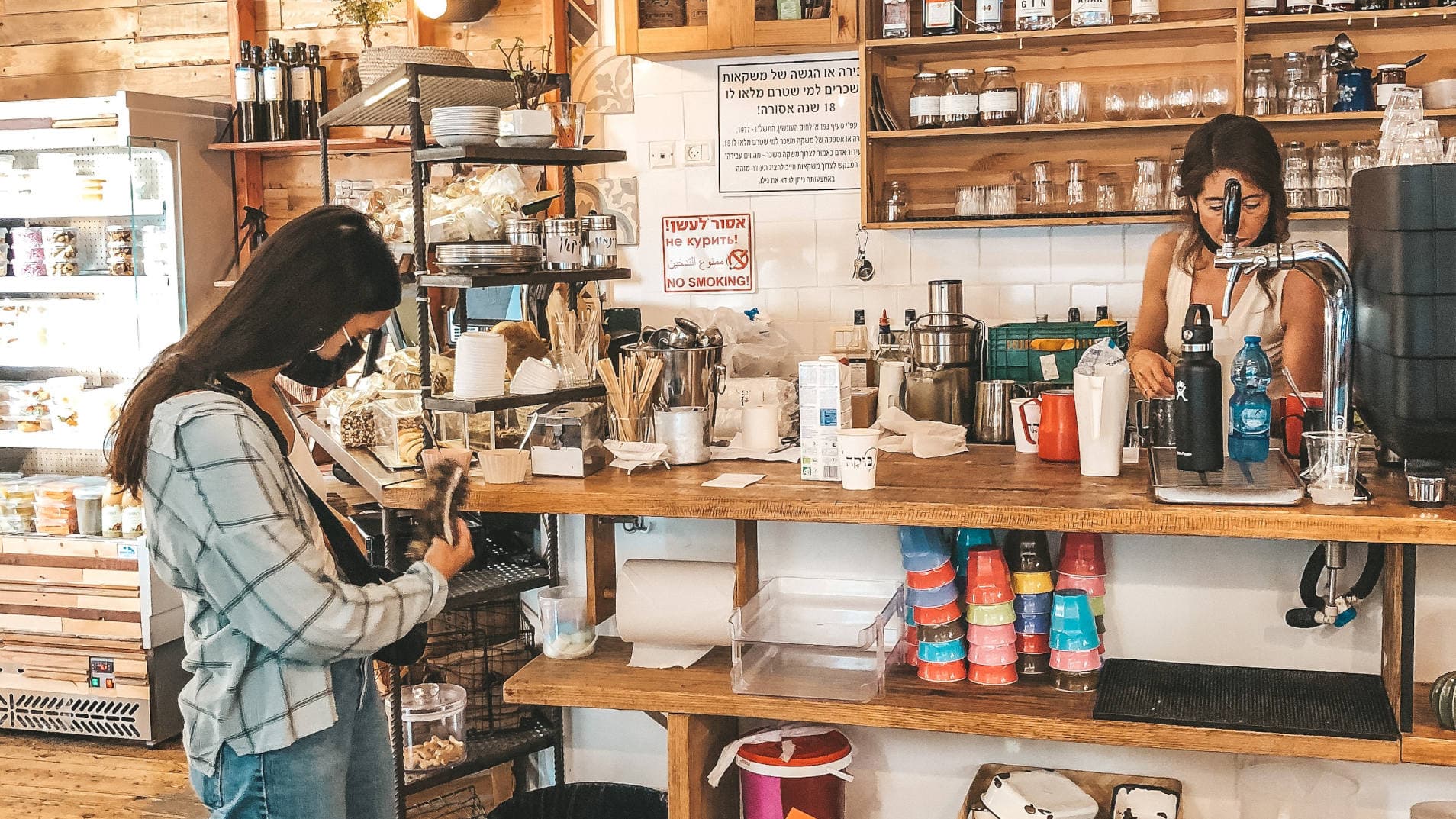 image of a woman paying for her order at a coffee shop